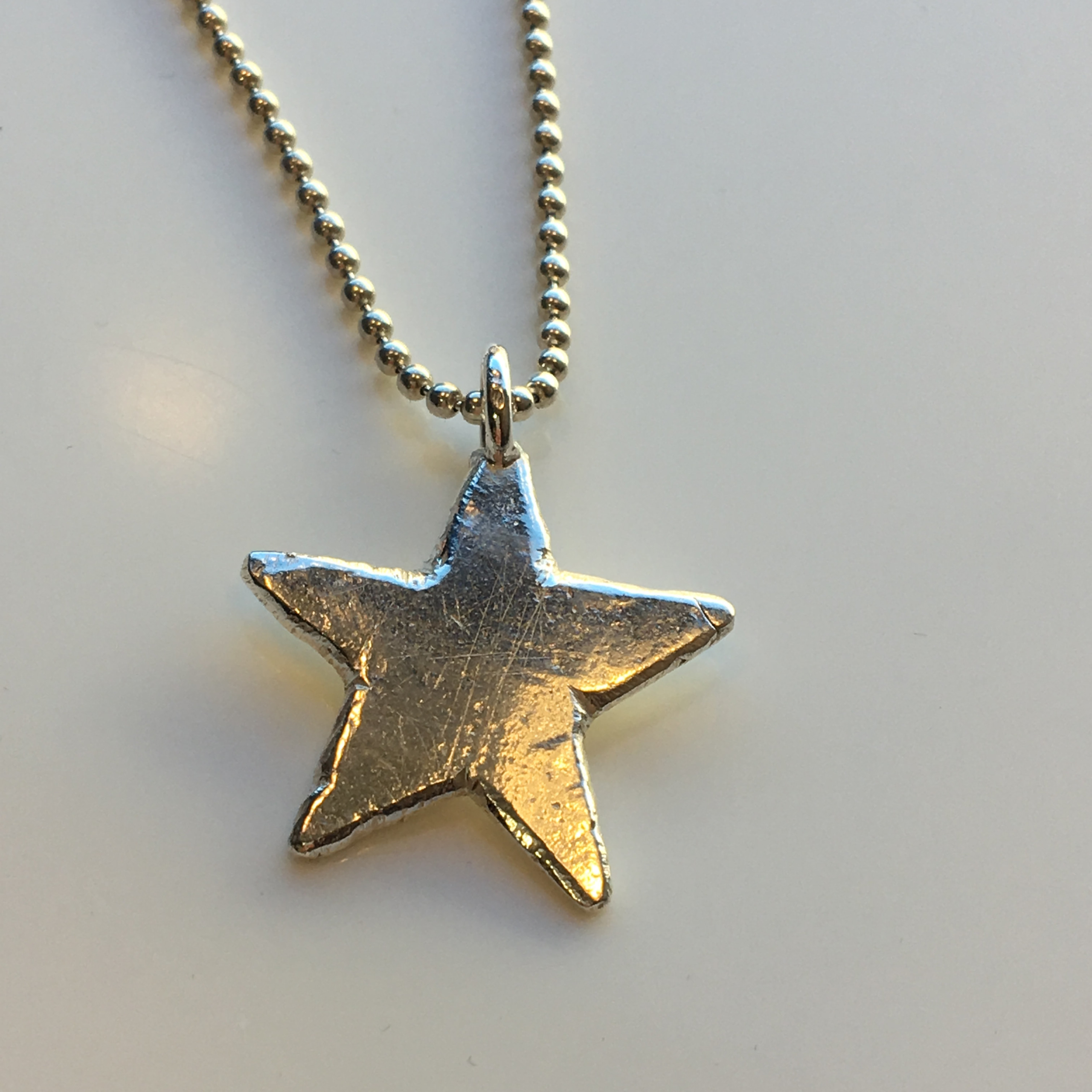 A solid silver star hand made to order. Totally unique.